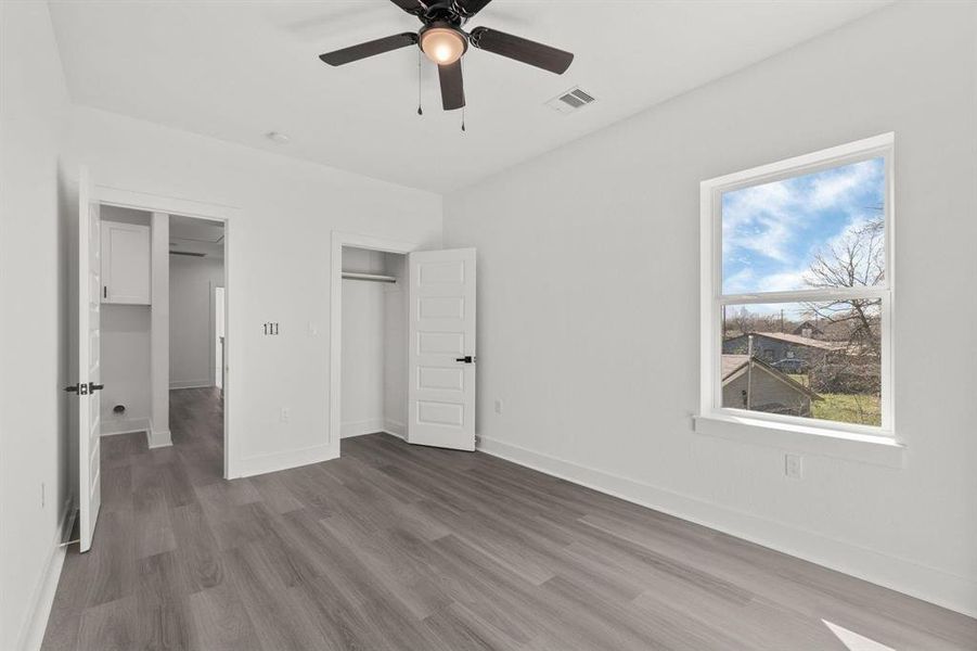 Here’s a secondary bedroom featuring two closets: a convenient reach-in closet and a walk-in closet located just off its private bathroom.