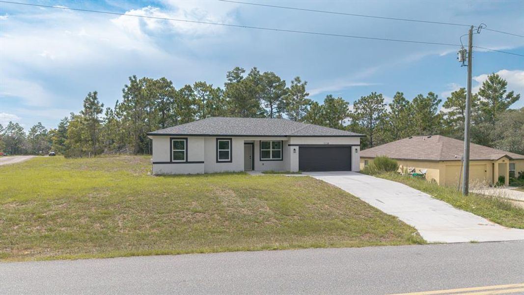 Front exterior of a new home in , Citrus Springs, FL, highlighting curb appeal (Image 23).