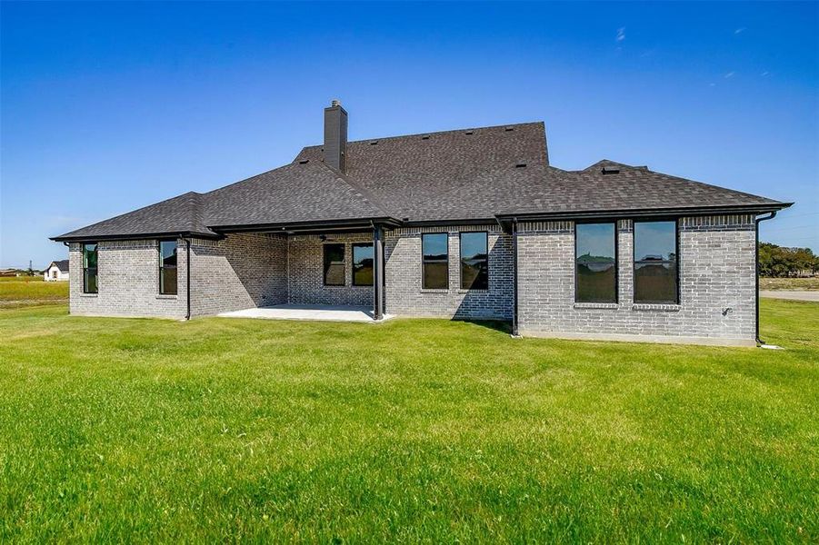 Back of house featuring a patio and a lawn