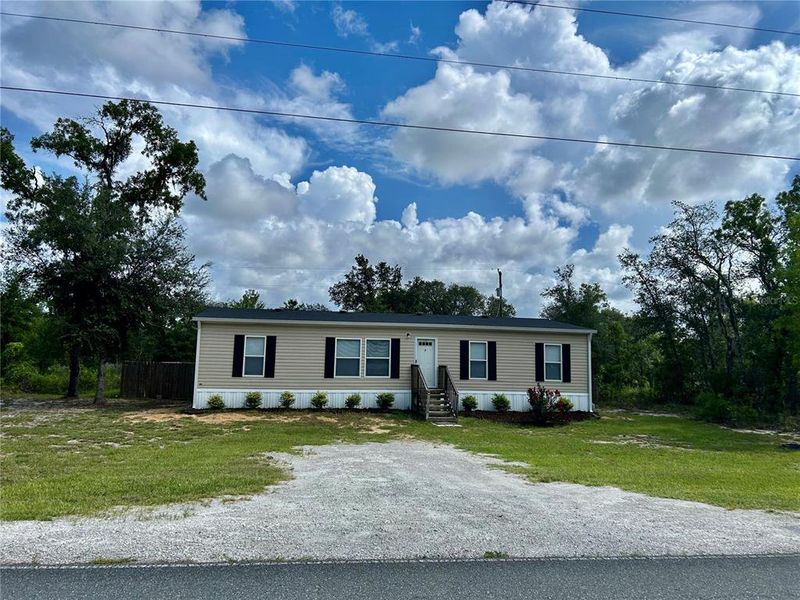 Front exterior of a new home in , Bronson, FL, highlighting curb appeal (Image 1). Front exterior of a new home in , Bronson, FL, highlighting curb appeal (Image 1).