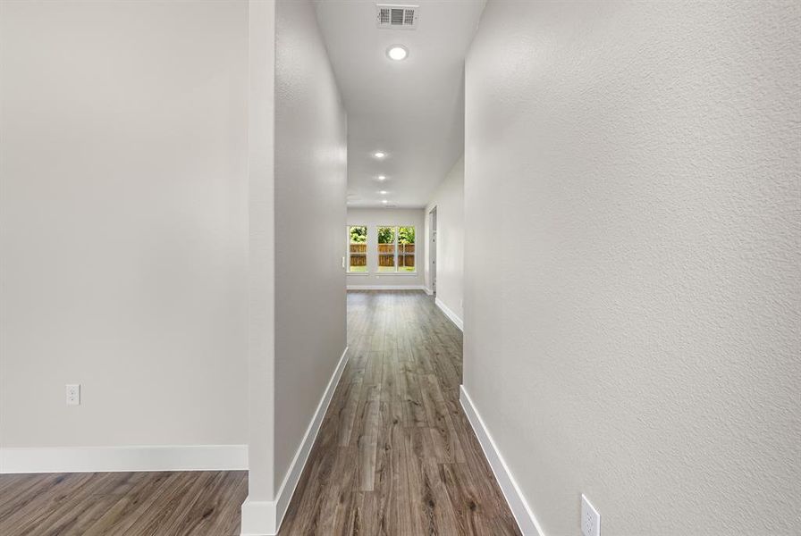 Corridor with dark wood-style floors and recessed lighting Corridor with dark wood-style floors and recessed lighting