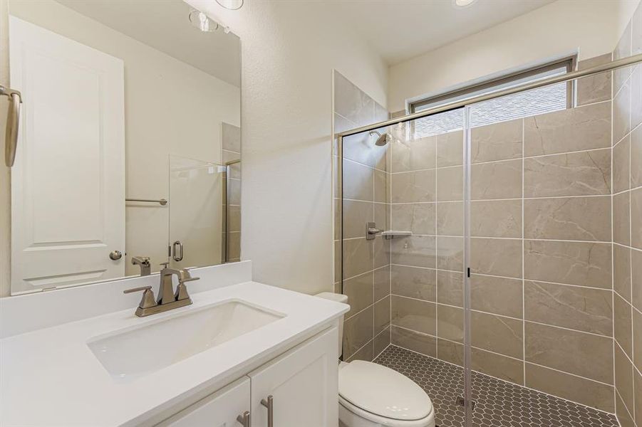 Full bathroom with vanity and a shower stall