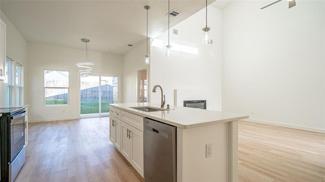 Contemporary style light fixtures, fenced back yard.