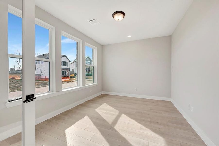 Unfurnished room with light wood-style floors and recessed lighting