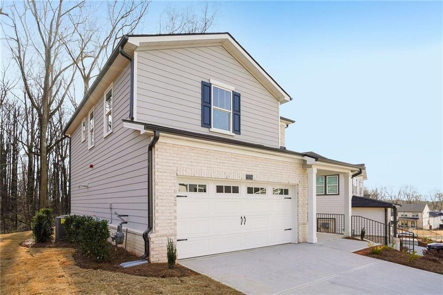 Front exterior of a new home in Hemingway - Reserve Series, Cumming, GA, highlighting curb appeal (Image 2). Front exterior of a new home in Hemingway - Reserve Series, Cumming, GA, highlighting curb appeal (Image 2).
