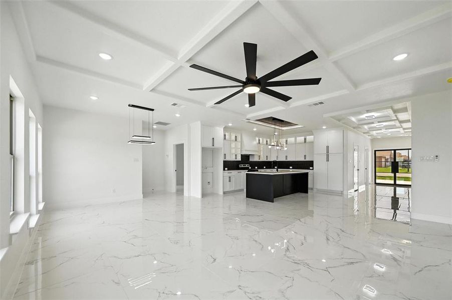 Unfurnished living room with recessed lighting, coffered ceiling, beam ceiling, a ceiling fan, and a chandelier