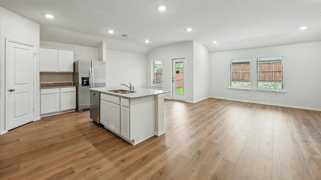 Open-concept living area with wood-finish flooring