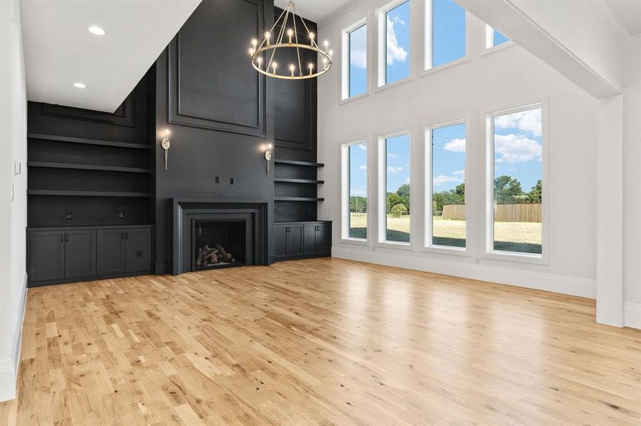 The oversized fireplace centers the room with built-ins flanking each side.