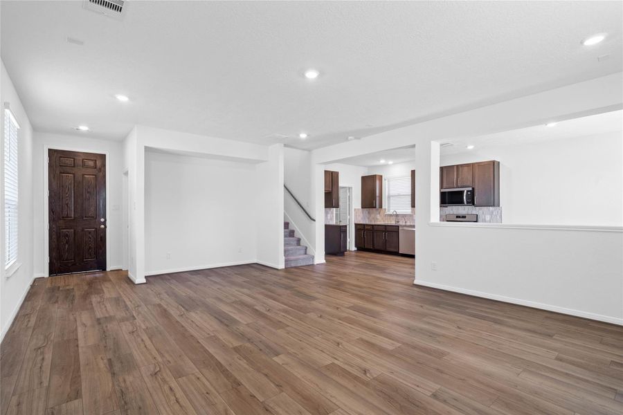 Step inside your new home, where the Layton Lake Driftwood vinyl plank flooring and fresh, bright paint create a warm and inviting entryway. Discover a distinctive architectural detail with this built-in wall niche, ideal for creating a custom entertainment center, showcasing built-in shelving, or fitting a hutch. This feature adds both visual interest and practical function to the main living space.