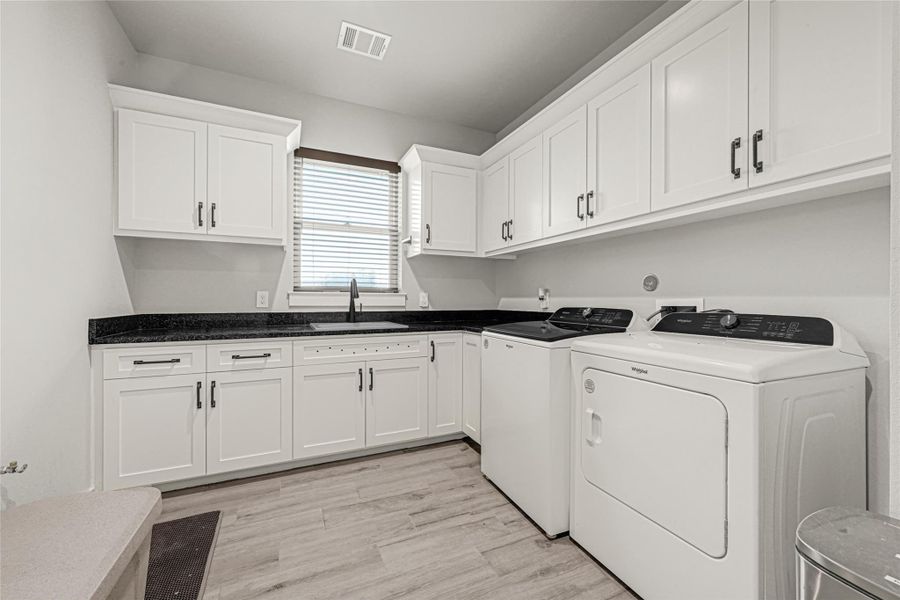 oversized laundry with sink and lots of extra storage. Pre-plummed for pet wash