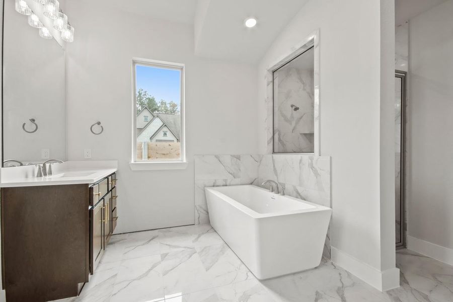 Full bathroom with a soaking tub, marble finish floor, vanity, and recessed lighting Full bathroom with a soaking tub, marble finish floor, vanity, and recessed lighting