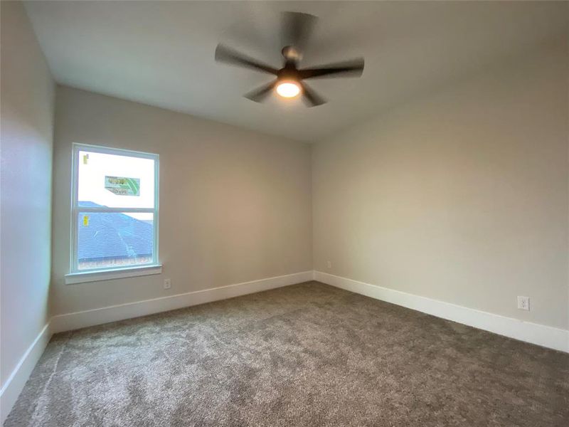 Unfurnished room with ceiling fan and carpet floors