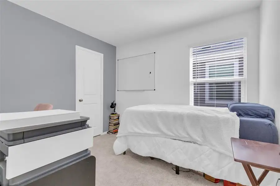 Bedroom with light carpet