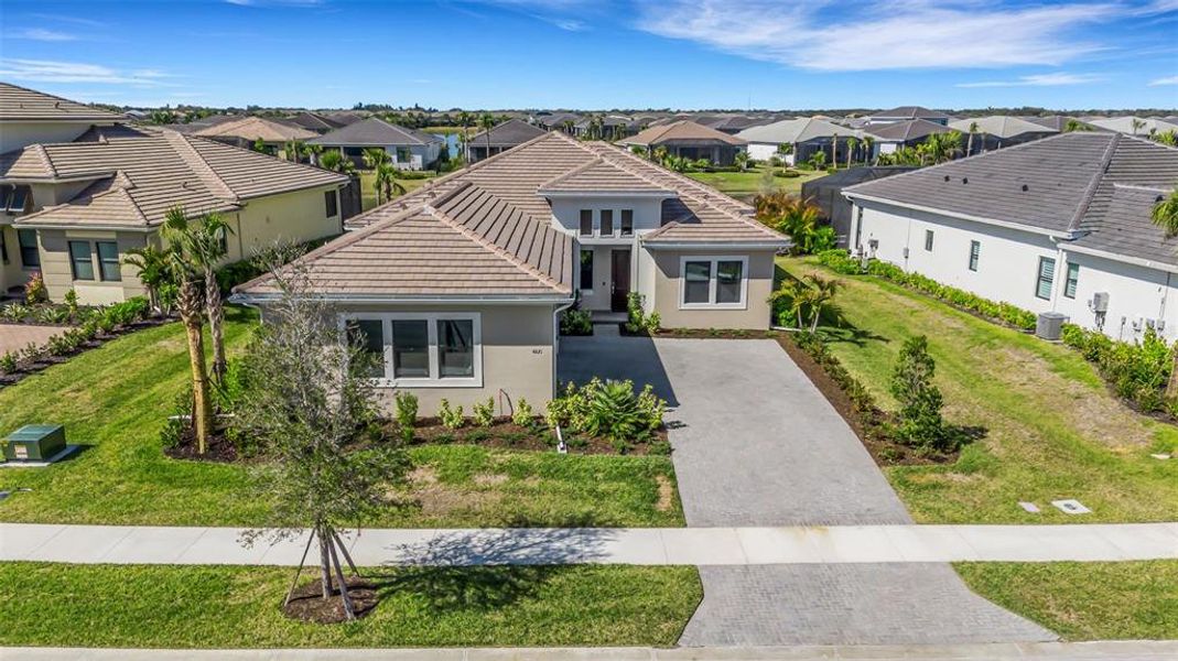Front exterior of a new home in Artistry Sarasota, Sarasota, FL, highlighting curb appeal (Image 21).