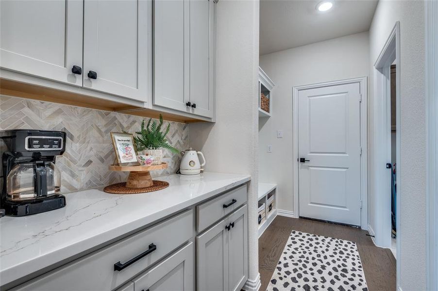 Laundry area with dark wood-style flooring and baseboards