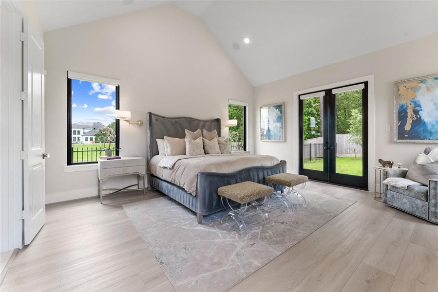 The primary suite offers a private retreat with vaulted ceilings, wide plank flooring, and direct access to the covered patio. Automatic shades and upgraded window treatments add comfort and privacy.
