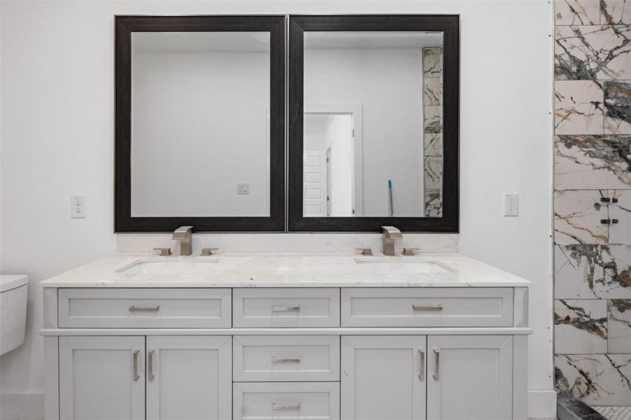 Bathroom with walk in shower, vanity, and toilet