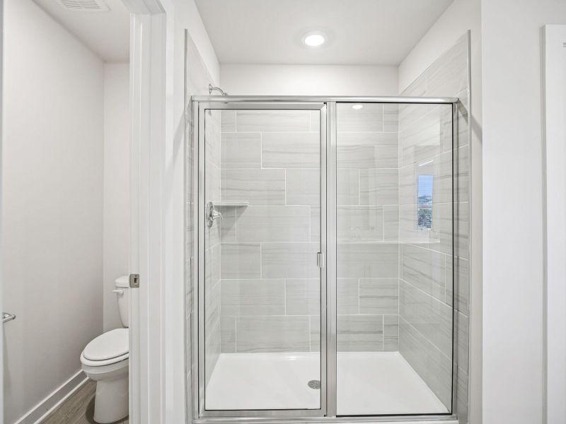 The primary bathroom offers dual vanity sinks and a walk-in shower. The primary bathroom offers dual vanity sinks and a walk-in shower.