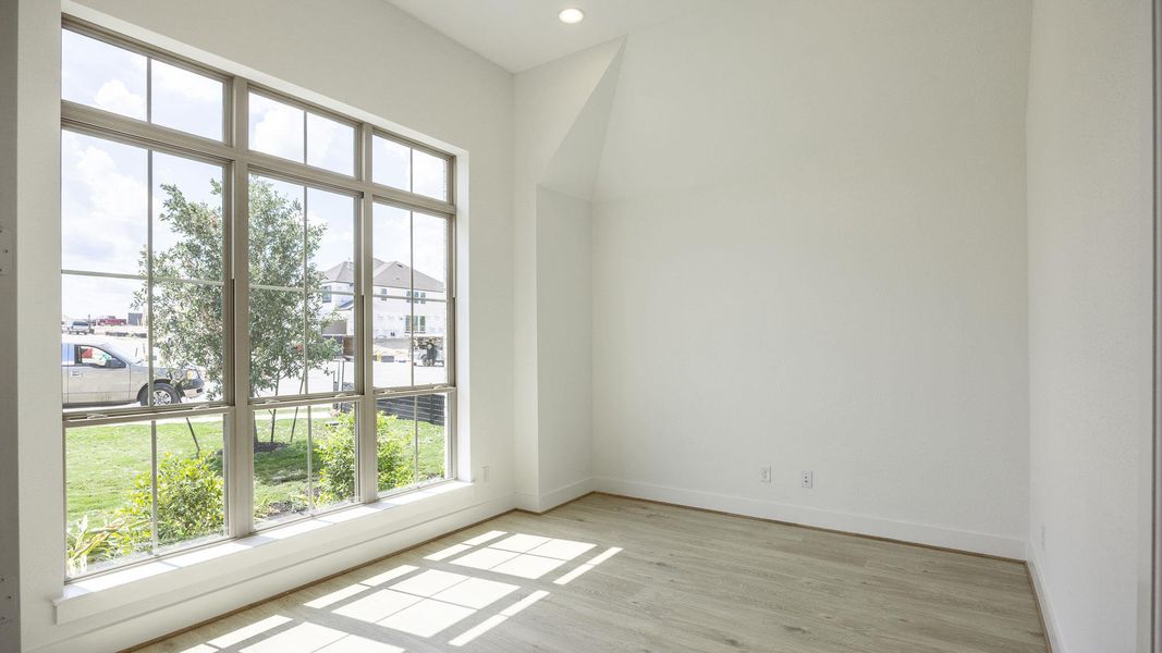 Empty room with light wood-style floors and recessed lighting Empty room with light wood-style floors and recessed lighting
