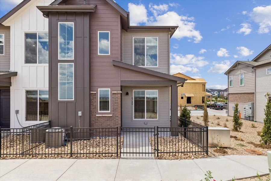 Front exterior of a new home in Townes at Skyline Ridge Pacific Collection, Castle Pines, CO, highlighting curb appeal (Image 1). Front exterior of a new home in Townes at Skyline Ridge Pacific Collection, Castle Pines, CO, highlighting curb appeal (Image 1).