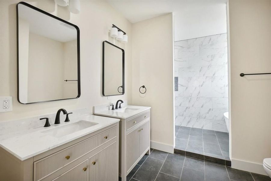 Bathroom featuring tile patterned flooring, vanity, and toilet