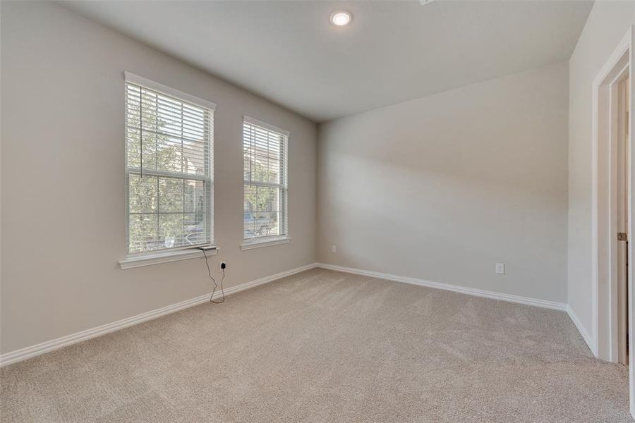 Carpeted empty room featuring a healthy amount of sunlight