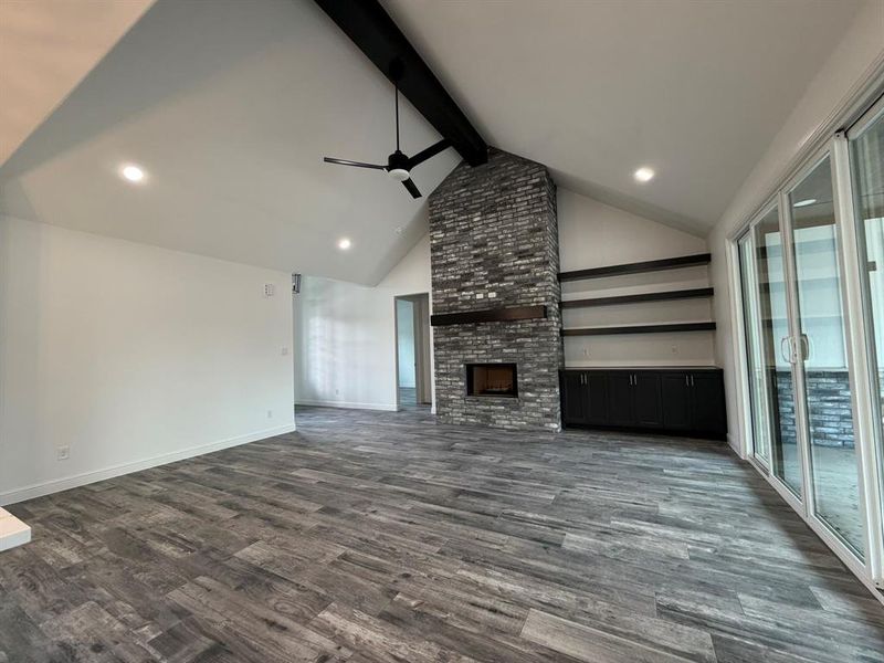 Vaulted ceilings featuring a dark wood beam and recessed lighting