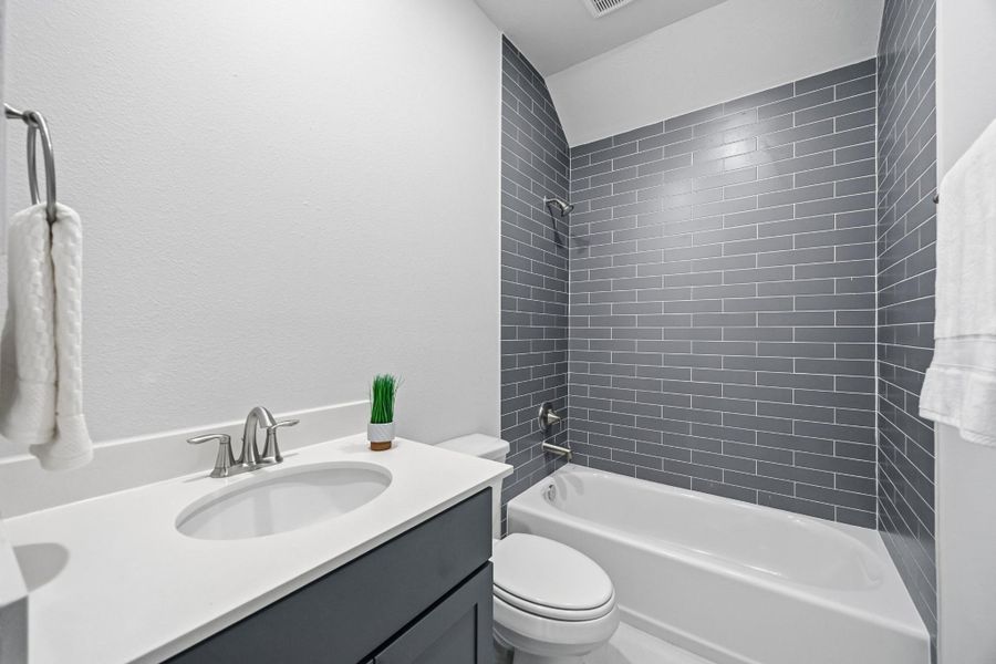 Classic Vibes: The chic Secondary Bath, nestled between the secondary bedrooms, offers a stylish and contemporary touch to your abode.