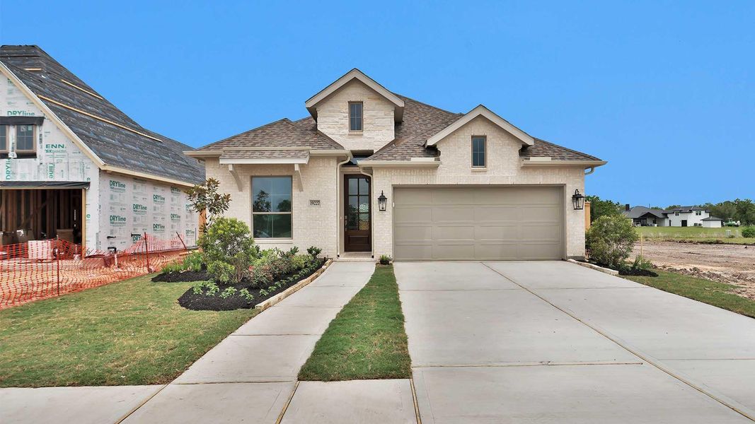 Front exterior of a new home in Valencia, Manvel, TX, highlighting curb appeal (Image 2). Front exterior of a new home in Valencia, Manvel, TX, highlighting curb appeal (Image 2).