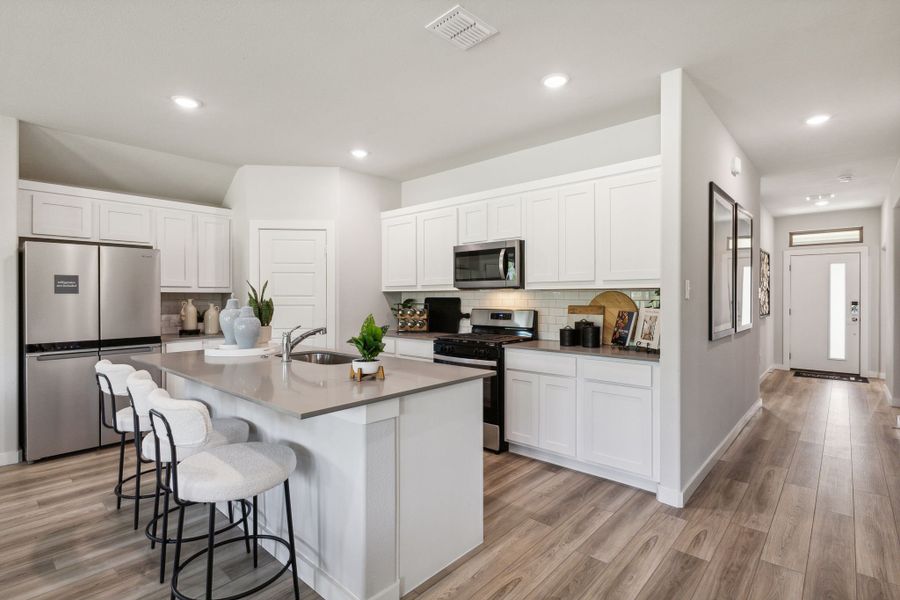 Kitchen in the Emmy II home plan by Trophy Signature Homes - REPRESENTATIVE PHOTO