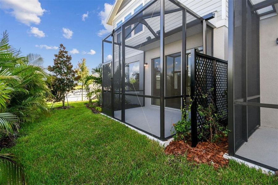 Exterior details and patio area of a home in North River Ranch – Townhomes, Parrish (Image 2).