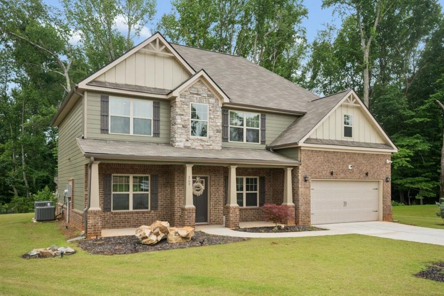 Front exterior of a new home in Nine Oaks, Locust Grove, GA, highlighting curb appeal (Image 2). Front exterior of a new home in Nine Oaks, Locust Grove, GA, highlighting curb appeal (Image 2).