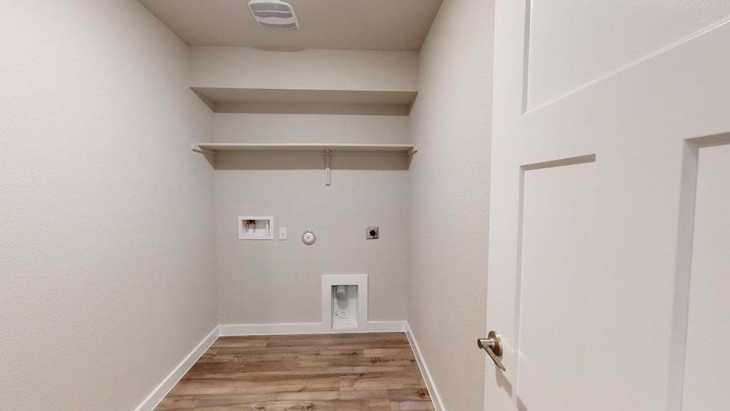 Ample shelving in this dedicated laundry space offers practical organization. Ample shelving in this dedicated laundry space offers practical organization.