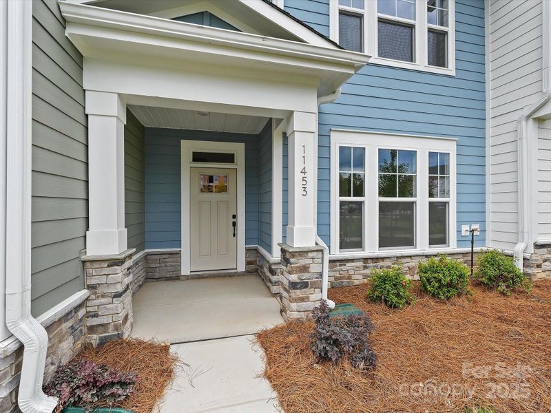 Front exterior of a new home in North Creek Village - Townhomes, Huntersville, NC, highlighting curb appeal (Image 2). Front exterior of a new home in North Creek Village - Townhomes, Huntersville, NC, highlighting curb appeal (Image 2).