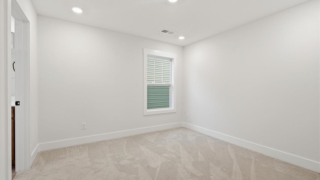Memorable space with walk-in closet, soft carpeting, and striking natural light from large windows