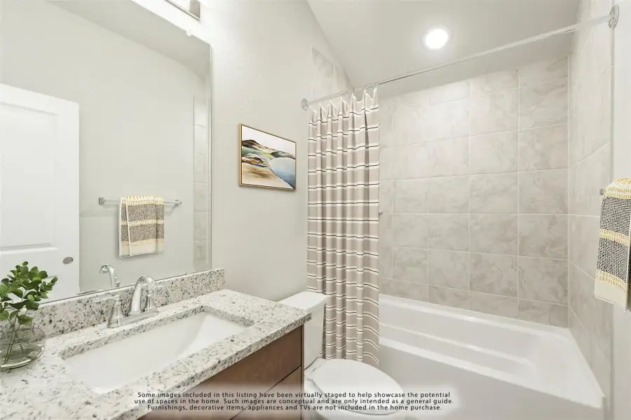 Bathroom with granite countertop vanity, tiled tub-shower combo, and large mirror
