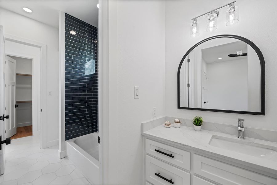 Stylish Jack & Jill bathroom with modern finishes and convenient dual access.