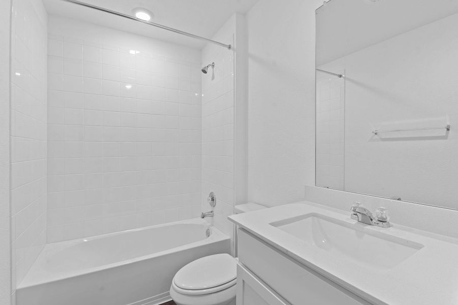 Full bathroom featuring tub / shower combination, vanity, and toilet