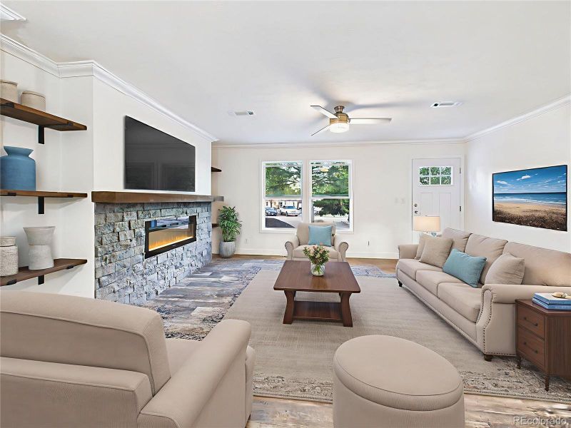 Virtually Staged Open-concept great room with wide plank luxury vinyl flooring and recessed lighting.