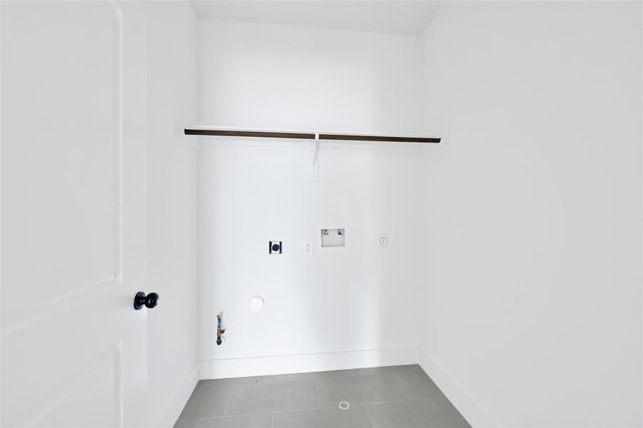 Spacious walk-in closet with built-in shelving and ample storage. Spacious walk-in closet with built-in shelving and ample storage.