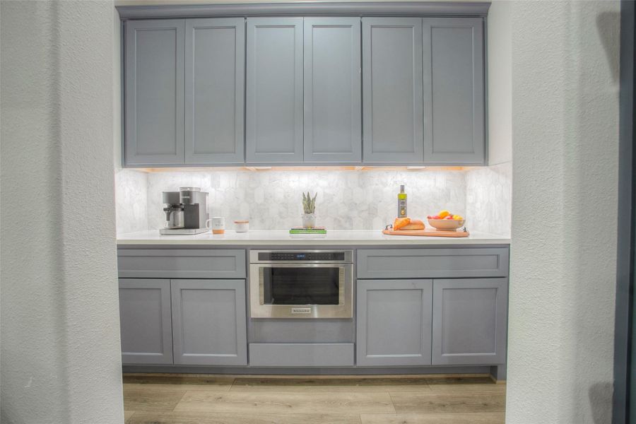 Butler pantry off of the kitchen with under cabinet lighting.  The perfect place for a coffee bar.