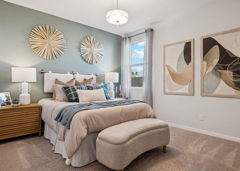 A bedroom with a bed and lamps. A bedroom with a bed and lamps.