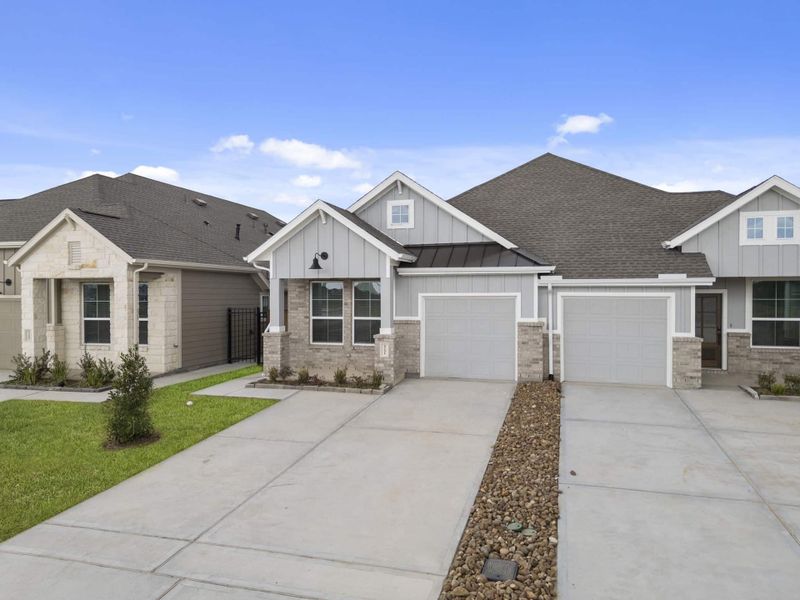 Front exterior of a new home in Meridiana, Manvel, TX, highlighting curb appeal (Image 22).
