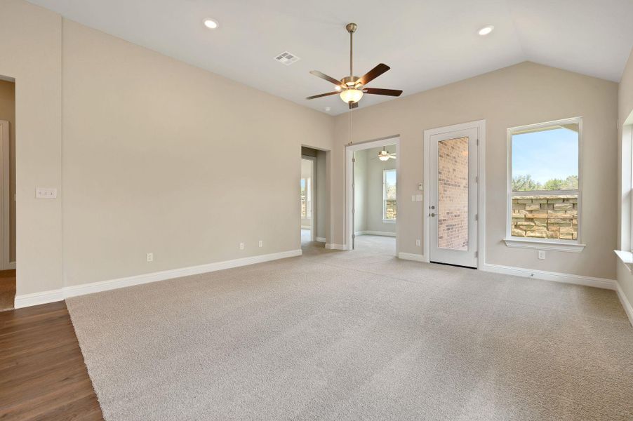 Unfurnished room featuring plenty of natural light, a ceiling fan, recessed lighting, and lofted ceiling