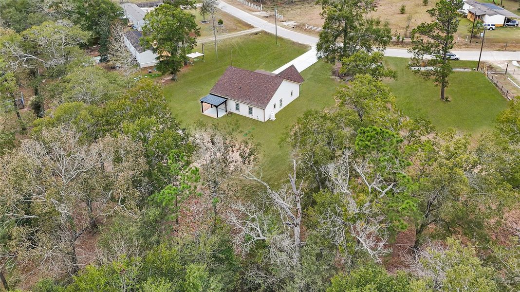 Nestled in a spacious, wooded area, this charming home features a large yard with surrounding trees for privacy. The house has a simple, classic design with a covered porch, and it's located near a quiet road. Perfect for those seeking a serene, natural setting. Nestled in a spacious, wooded area, this charming home features a large yard with surrounding trees for privacy. The house has a simple, classic design with a covered porch, and it's located near a quiet road. Perfect for those seeking a serene, natural setting.