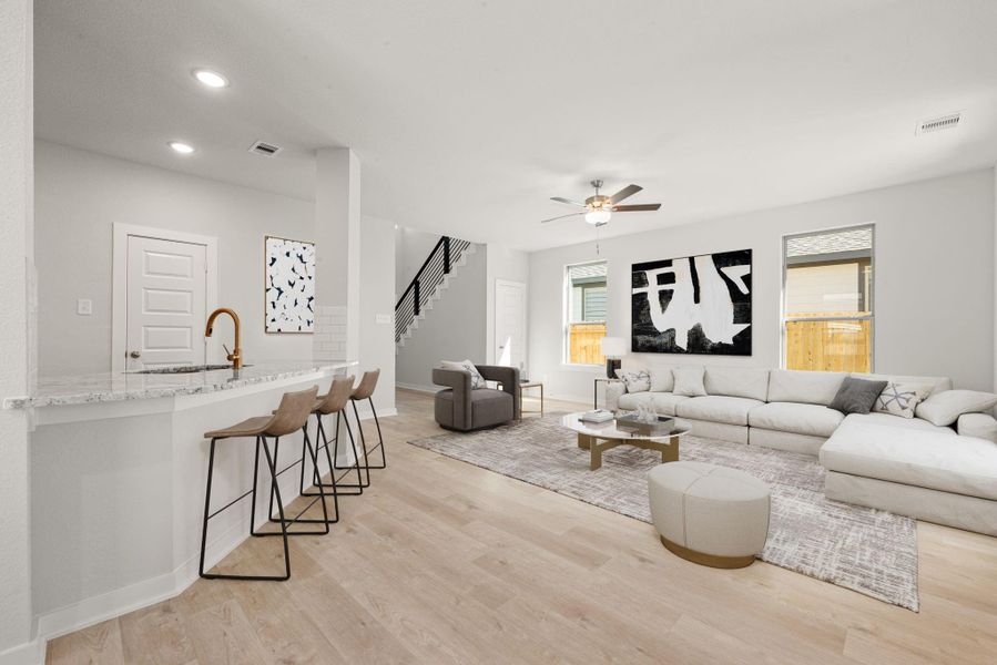 This modern open-concept layout features a seamless connection between the kitchen, dining, and living spaces. Light-toned flooring, recessed lighting, and neutral finishes create a bright, welcoming atmosphere that feels both spacious and refined. This modern open-concept layout features a seamless connection between the kitchen, dining, and living spaces. Light-toned flooring, recessed lighting, and neutral finishes create a bright, welcoming atmosphere that feels both spacious and refined.