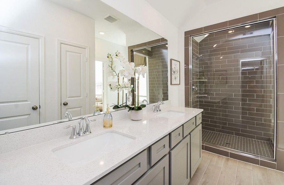 Luxury bathroom retreat with dual sinks and a grand walk-in shower that feels like a spa.