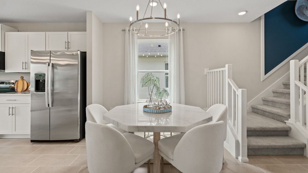 Open Concept Dining and Kitchen Area in Ponte Vedra New Home Plan in Hamilton Bluff in Haines City, FL by DRB Homes