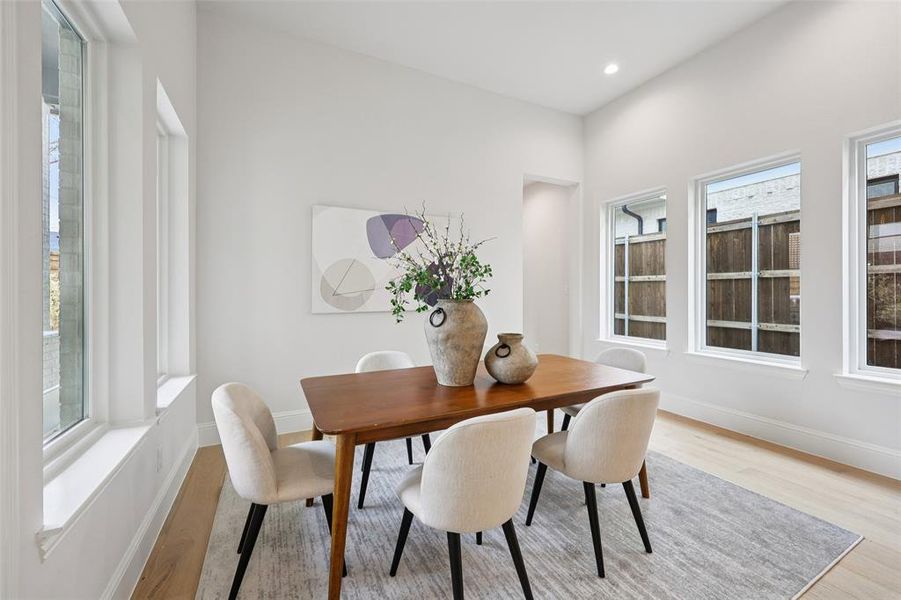 Dining space featuring light wood finished floors and recessed lighting