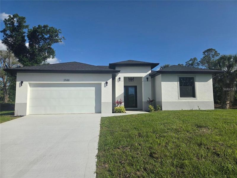 Front exterior of a new home in , North Port, FL, highlighting curb appeal (Image 1). Front exterior of a new home in , North Port, FL, highlighting curb appeal (Image 1).